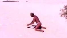 Tanned guy on beach in tiny string thong (temporarily!)