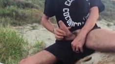 He wanks in the dunes